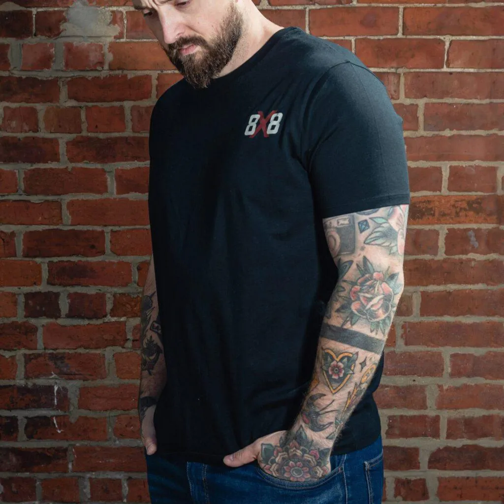 Three-quarter front view of a black 8x8 T-shirt with the small chest logo.