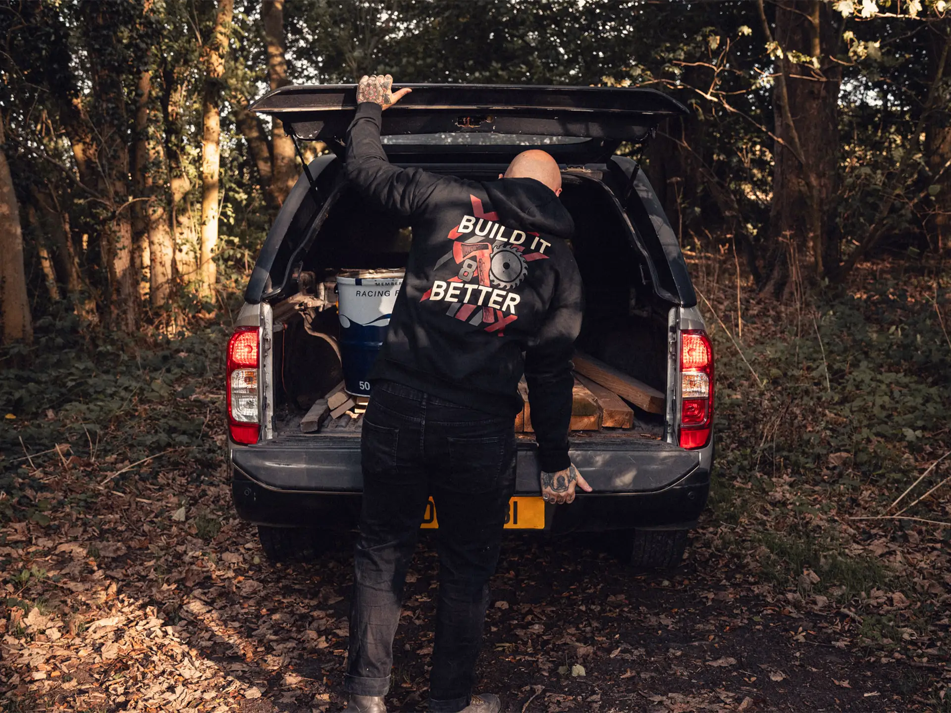 8×8 Build It Better black hoodie at a pickup tailgate