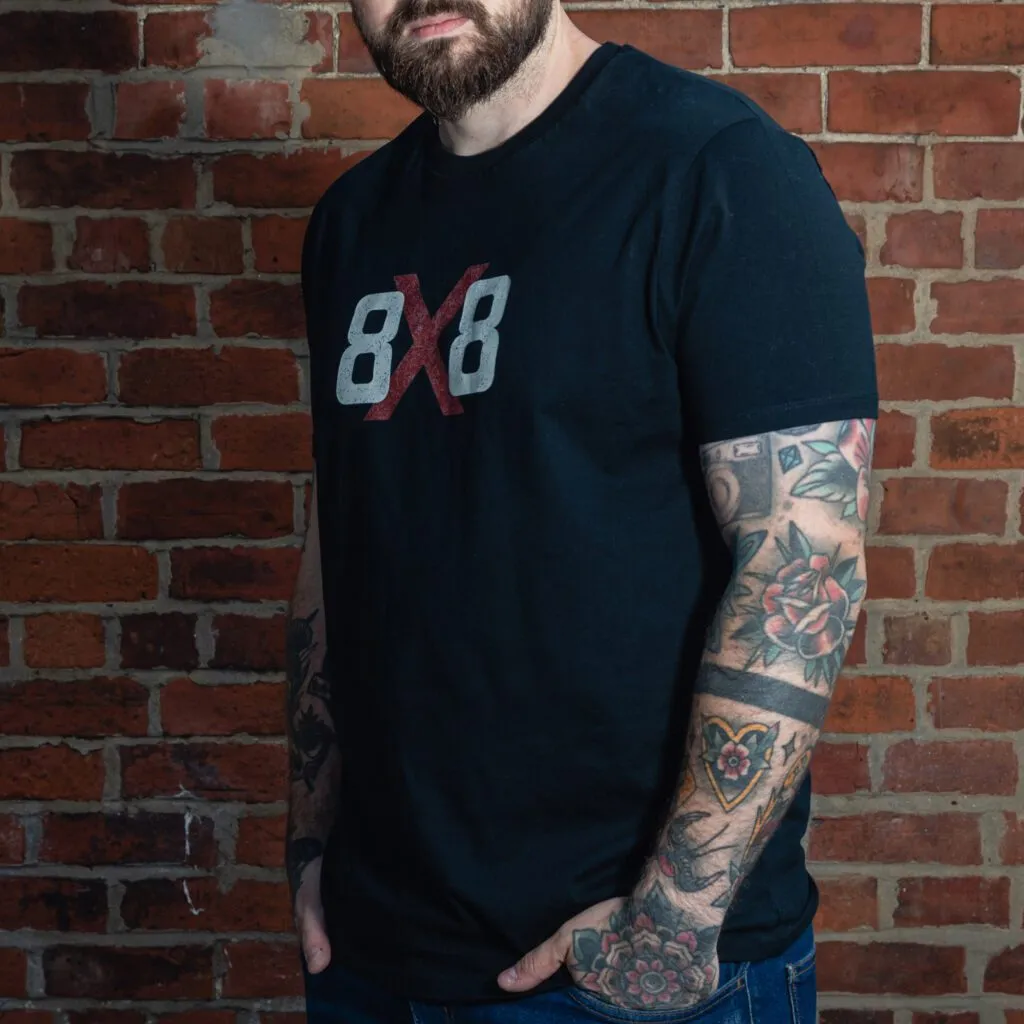 Three-quarter front view of the black 8x8 OG T-shirt with large distressed chest logo.